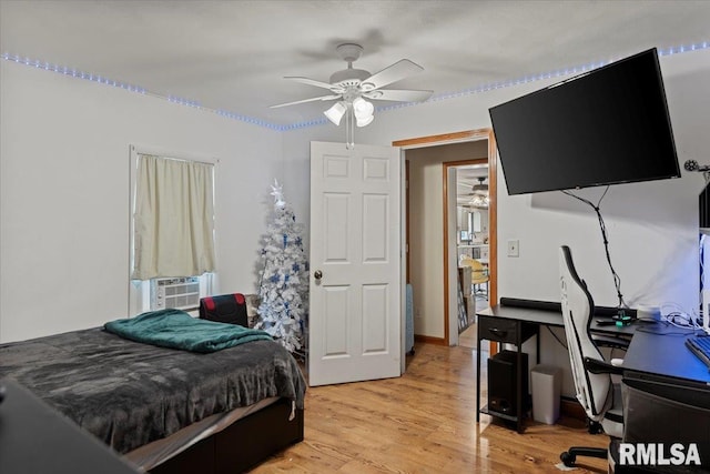14455 E Dutch Henry Rd, Lewistown, IL 61542 - bedroom featuring cooling unit, light wood-style floors, an office area, and a ceiling fan