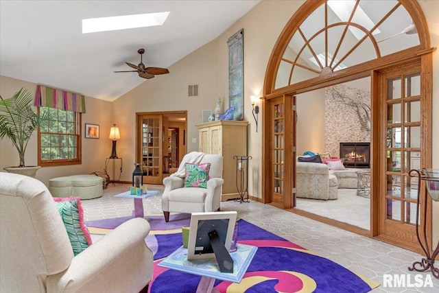 9 Windfall Ln, Cantrall, IL 62625 - living room with a skylight, french doors, a fireplace, high vaulted ceiling, and a ceiling fan