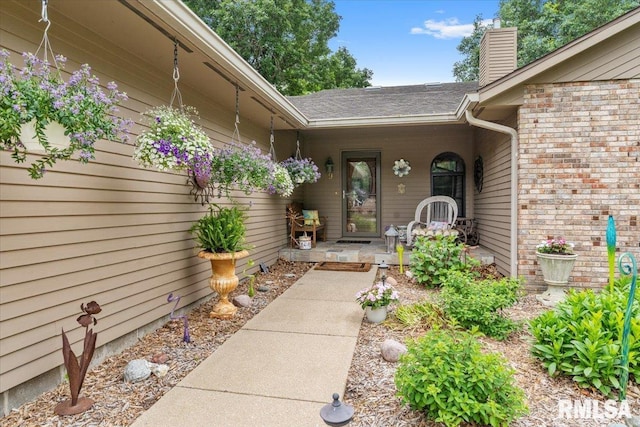 9 Windfall Ln, Cantrall, IL 62625 - entrance to property featuring a chimney, a shingled roof, covered porch, and brick siding