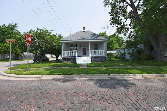 931 W Vandeveer St, Taylorville, IL 62568 - view of front of home featuring a porch, a chimney, and roof with shingles