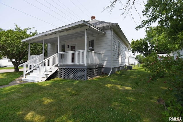 931 W Vandeveer St, Taylorville, IL 62568 - view of front of property featuring a front lawn, covered porch, and a chimney