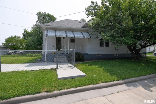 931 W Vandeveer St, Taylorville, IL 62568 - bungalow-style home featuring a fenced front yard, a gate, and roof with shingles