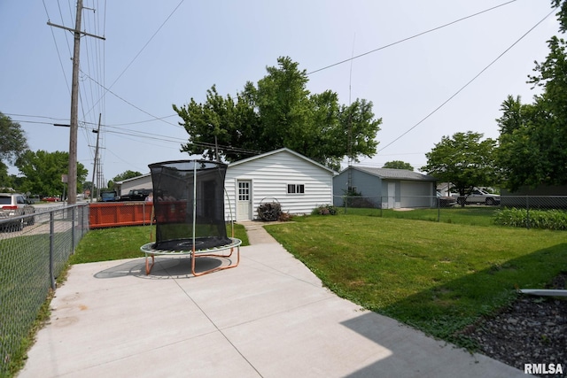 931 W Vandeveer St, Taylorville, IL 62568 - fenced backyard featuring a trampoline and a patio area
