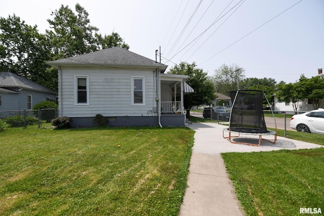 931 W Vandeveer St, Taylorville, IL 62568 - view of side of property with a trampoline and covered porch