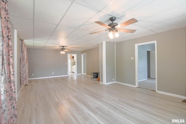 931 W Vandeveer St, Taylorville, IL 62568 - unfurnished living room featuring ceiling fan, light wood-type flooring, and a paneled ceiling