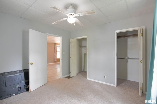 931 W Vandeveer St, Taylorville, IL 62568 - unfurnished bedroom featuring two closets, a paneled ceiling, carpet floors, and ceiling fan