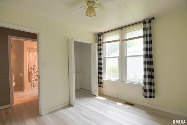 931 W Vandeveer St, Taylorville, IL 62568 - unfurnished bedroom with light wood-type flooring, a closet, and a ceiling fan