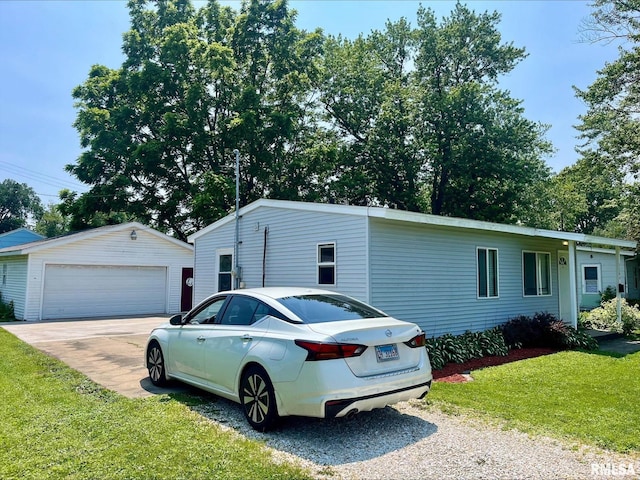 1164 Arcadia Dr, Galesburg, IL 61401 - view of side of property featuring an outbuilding, a garage, and a yard