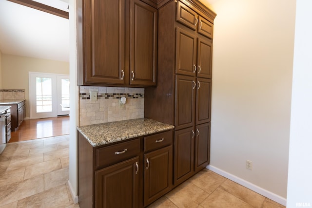 6718 Shadow Ln, Quincy, IL 62305 - kitchen featuring tasteful backsplash, light stone counters, and light tile patterned flooring