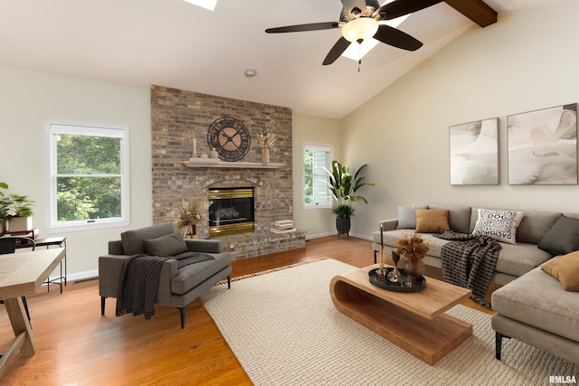6718 Shadow Ln, Quincy, IL 62305 - living room featuring a ceiling fan, light wood-style flooring, beam ceiling, a fireplace, and high vaulted ceiling