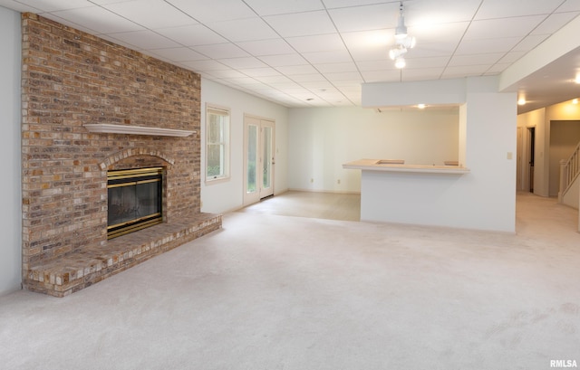 6718 Shadow Ln, Quincy, IL 62305 - unfurnished living room with carpet and a brick fireplace