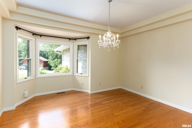 6718 Shadow Ln, Quincy, IL 62305 - spare room with a chandelier and light wood finished floors