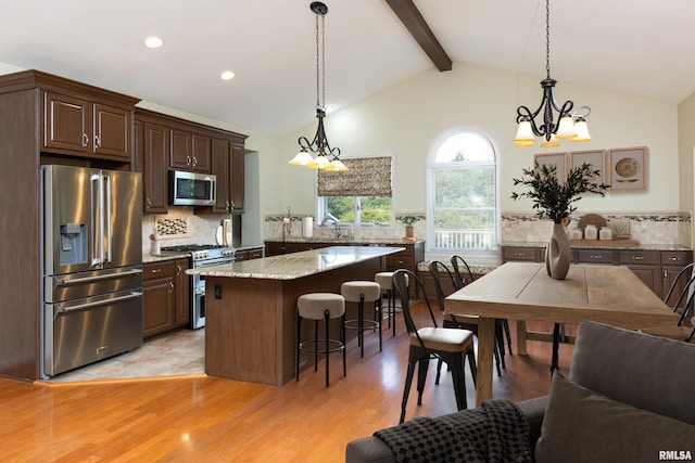 6718 Shadow Ln, Quincy, IL 62305 - kitchen featuring stainless steel appliances, a chandelier, a breakfast bar, tasteful backsplash, and recessed lighting