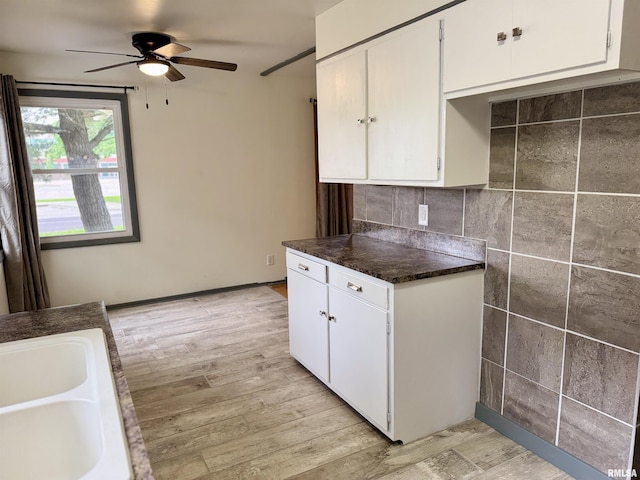 465 Fifer St, Galesburg, IL 61401 - kitchen with a ceiling fan, light wood-style flooring, dark countertops, and white cabinets