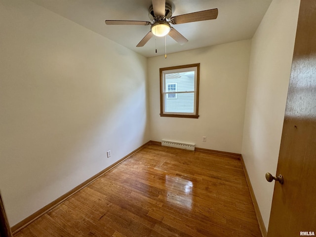 465 Fifer St, Galesburg, IL 61401 - empty room with a baseboard heating unit, wood finished floors, and ceiling fan