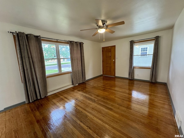 465 Fifer St, Galesburg, IL 61401 - spare room featuring a baseboard heating unit, wood finished floors, and a ceiling fan