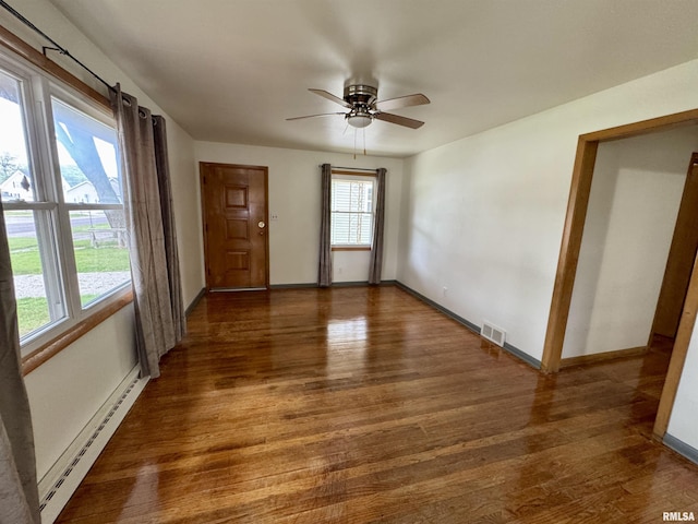 465 Fifer St, Galesburg, IL 61401 - unfurnished room featuring a baseboard radiator, wood finished floors, and ceiling fan