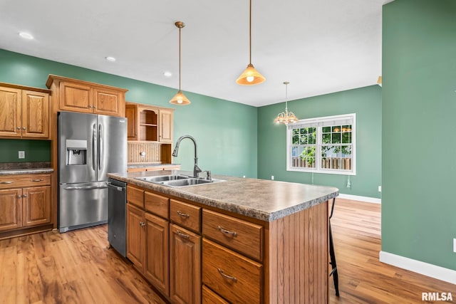230 Possum Pass Ct, Sherman, IL 62684 - kitchen featuring appliances with stainless steel finishes, light wood-style floors, a kitchen island with sink, hanging light fixtures, and recessed lighting