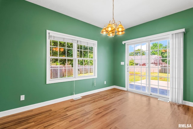 230 Possum Pass Ct, Sherman, IL 62684 - empty room with a chandelier, wood finished floors, and plenty of natural light