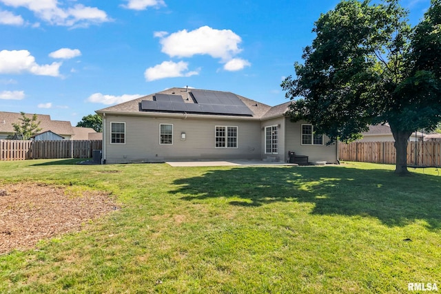 230 Possum Pass Ct, Sherman, IL 62684 - back of house featuring a patio, roof mounted solar panels, and a fenced backyard