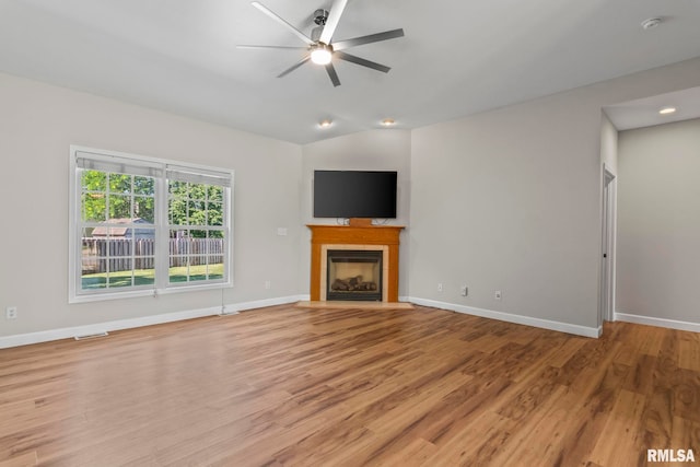 230 Possum Pass Ct, Sherman, IL 62684 - unfurnished living room featuring ceiling fan, a tiled fireplace, light wood-style floors, and lofted ceiling