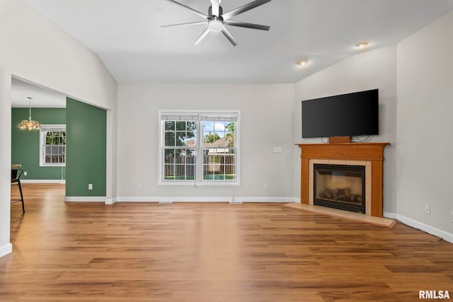 230 Possum Pass Ct, Sherman, IL 62684 - unfurnished living room with healthy amount of natural light, a tiled fireplace, light wood-style floors, a ceiling fan, and vaulted ceiling