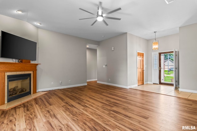 230 Possum Pass Ct, Sherman, IL 62684 - unfurnished living room with wood finished floors, a ceiling fan, and a fireplace