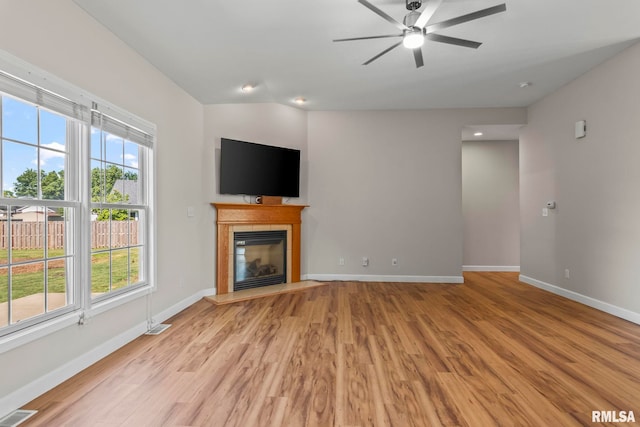 230 Possum Pass Ct, Sherman, IL 62684 - unfurnished living room featuring a ceiling fan, light wood-type flooring, and a tile fireplace