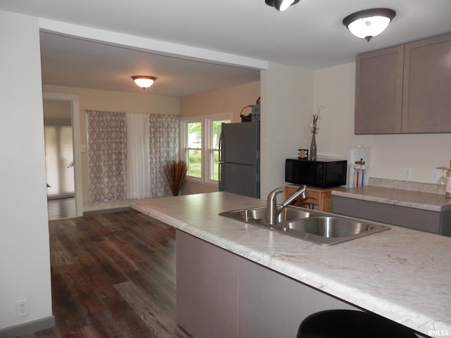 104 Henderson Rd, Knoxville, IL 61448 - kitchen featuring black microwave, freestanding refrigerator, dark wood-style floors, and light countertops