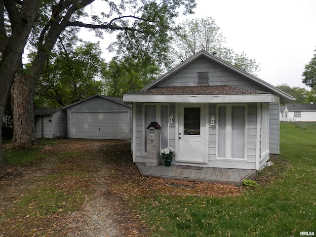 104 Henderson Rd, Knoxville, IL 61448 - view of front of home with an outbuilding, a detached garage, a front lawn, and driveway