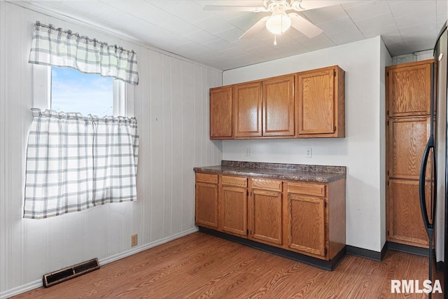 402 Linkins Ave, Tovey, IL 62570 - kitchen featuring brown cabinetry, wood finished floors, dark countertops, and ceiling fan