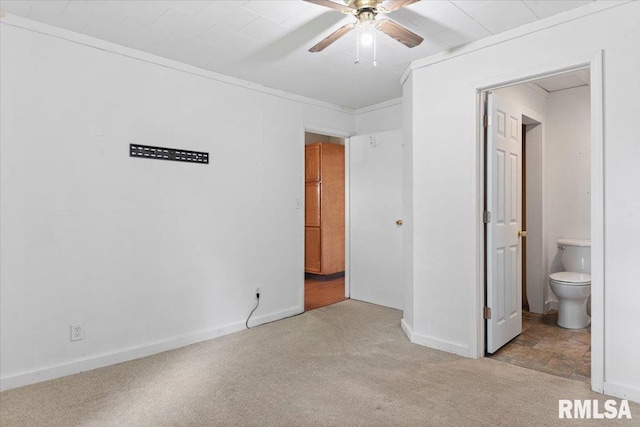 402 Linkins Ave, Tovey, IL 62570 - unfurnished bedroom with light colored carpet, ensuite bathroom, and ceiling fan