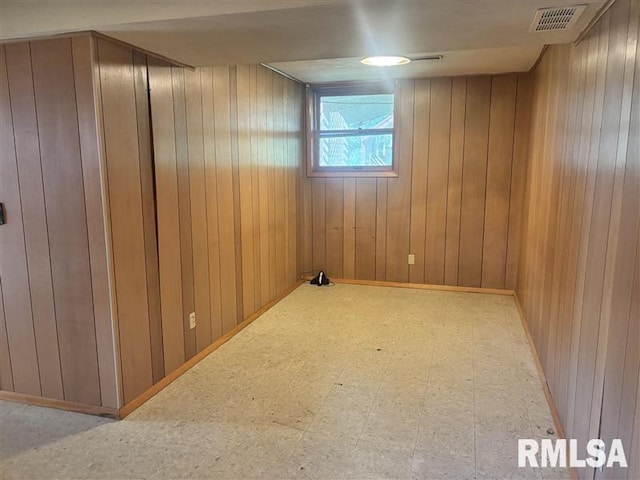 31 Glenwood Ln, Chatham, IL 62629 - empty room featuring wood walls and tile patterned floors