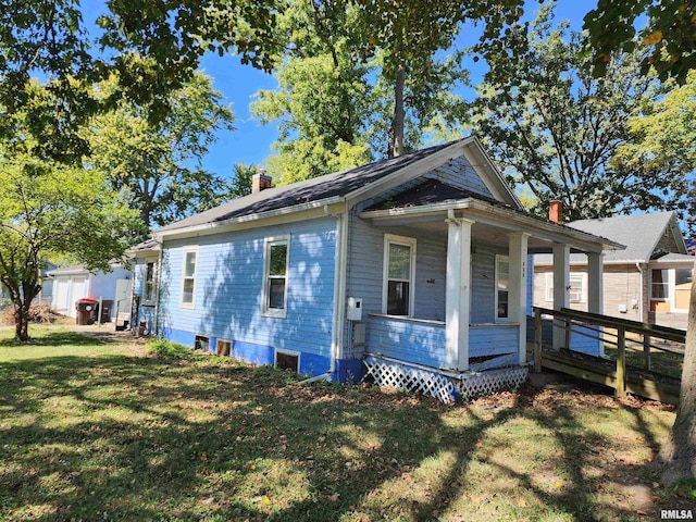 333 S Elm St, Lincoln, IL 62656 - view of front of property with a chimney, a front lawn, and a porch