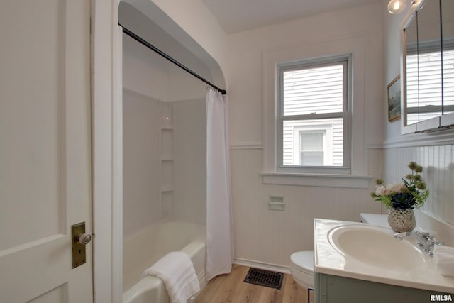 2204 Spring St, Quincy, IL 62301 - full bathroom featuring vanity, a wainscoted wall, plenty of natural light, wood finished floors, and shower / bath combo