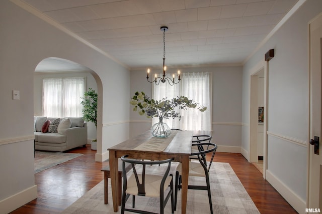 2204 Spring St, Quincy, IL 62301 - dining area featuring plenty of natural light, arched walkways, ornamental molding, a chandelier, and wood finished floors