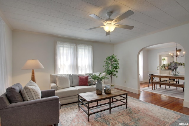 2204 Spring St, Quincy, IL 62301 - living room featuring arched walkways, ornamental molding, light wood-style flooring, a ceiling fan, and a chandelier