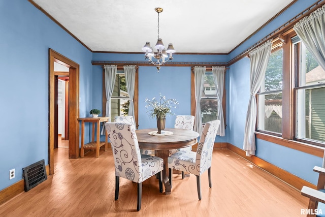 1537 N 4th St, Springfield, IL 62702 - dining room with a chandelier, crown molding, plenty of natural light, and light wood-type flooring