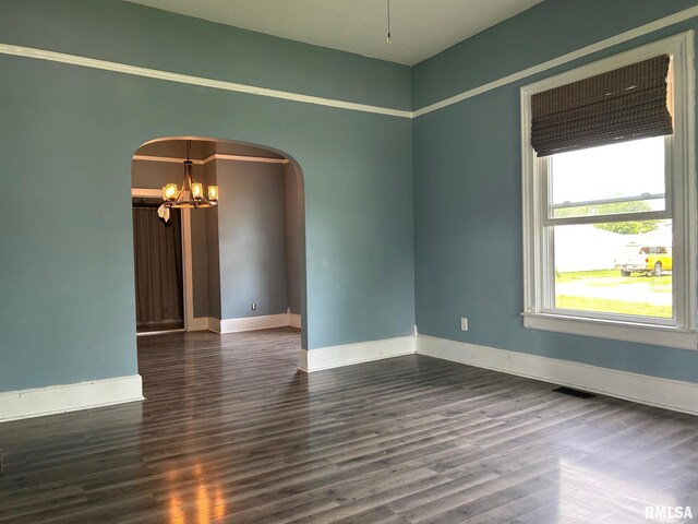 726 W N St, Auburn, IL 62629 - spare room with a chandelier, arched walkways, and wood finished floors