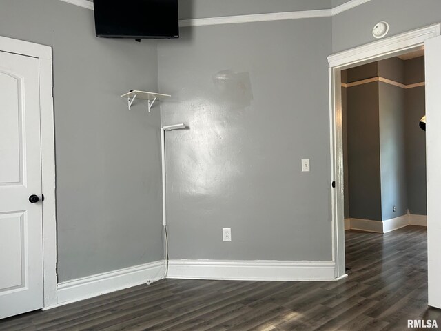 726 W N St, Auburn, IL 62629 - unfurnished bedroom featuring dark wood-type flooring and crown molding