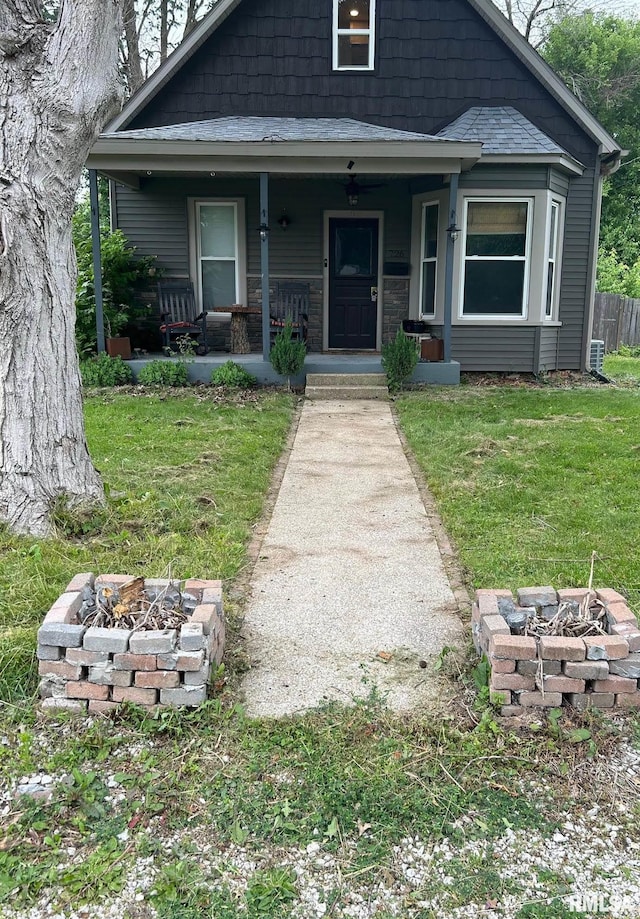 726 W N St, Auburn, IL 62629 - view of front facade featuring an outdoor fire pit, a front yard, covered porch, and roof with shingles