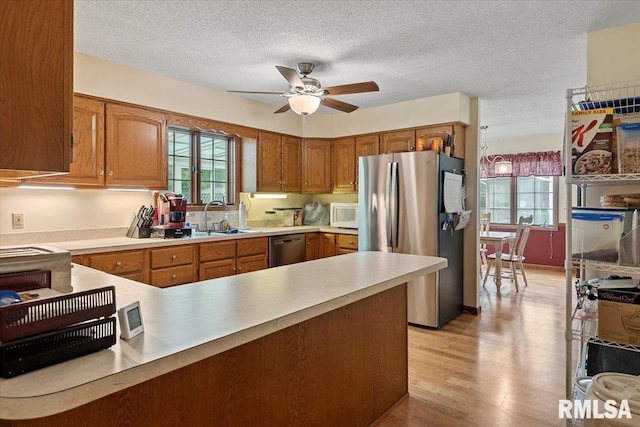 5309 Collins Way, Springfield, IL 62703 - kitchen featuring stainless steel appliances, healthy amount of natural light, a peninsula, ceiling fan, and a textured ceiling