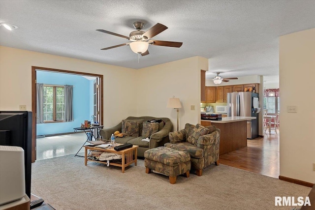 5309 Collins Way, Springfield, IL 62703 - living area with a ceiling fan, light carpet, and a textured ceiling