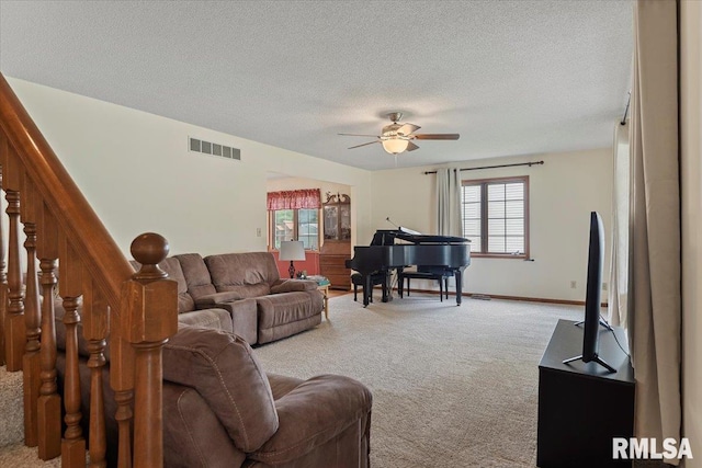 5309 Collins Way, Springfield, IL 62703 - living area featuring light colored carpet, a textured ceiling, a ceiling fan, and stairs
