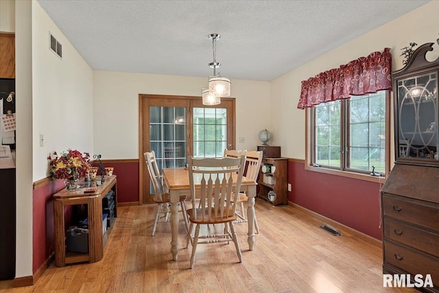 5309 Collins Way, Springfield, IL 62703 - dining area with light wood-type flooring, healthy amount of natural light, and a textured ceiling