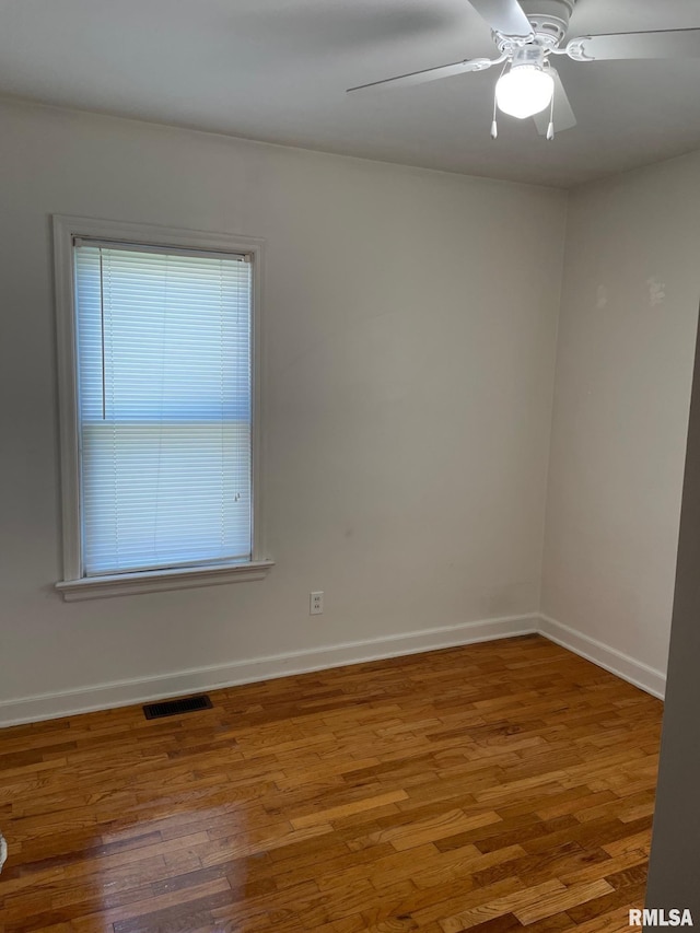 805 W Washington St, Pittsfield, IL 62363 - empty room featuring healthy amount of natural light, wood finished floors, and ceiling fan