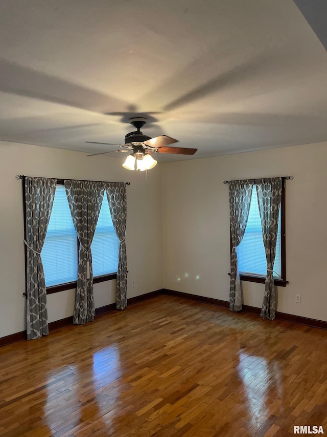 805 W Washington St, Pittsfield, IL 62363 - empty room featuring healthy amount of natural light, wood finished floors, and a ceiling fan