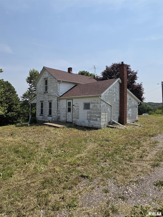 1355 Old Wagon Rd, Knoxville, IL 61448 - back of property featuring a chimney, stone siding, and a yard