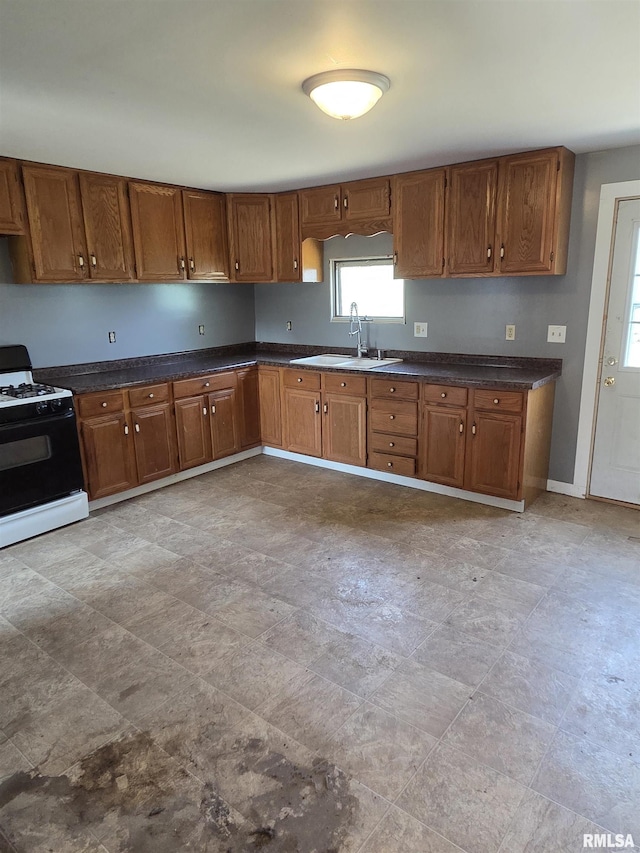 1355 Old Wagon Rd, Knoxville, IL 61448 - kitchen featuring range with gas stovetop, dark countertops, and brown cabinets