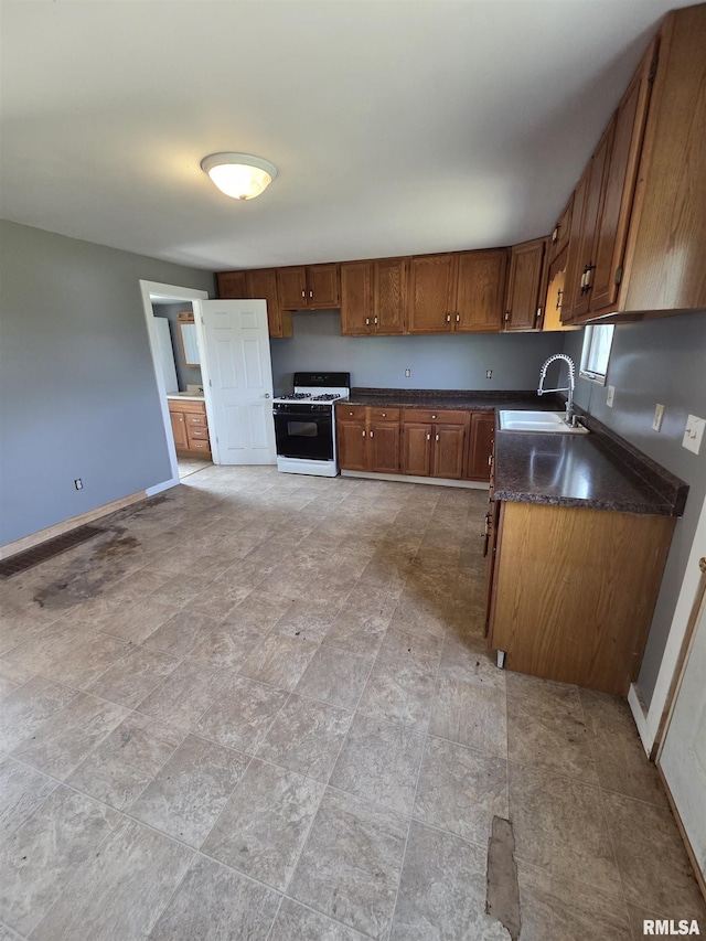 1355 Old Wagon Rd, Knoxville, IL 61448 - kitchen featuring gas range gas stove, dark countertops, and brown cabinets